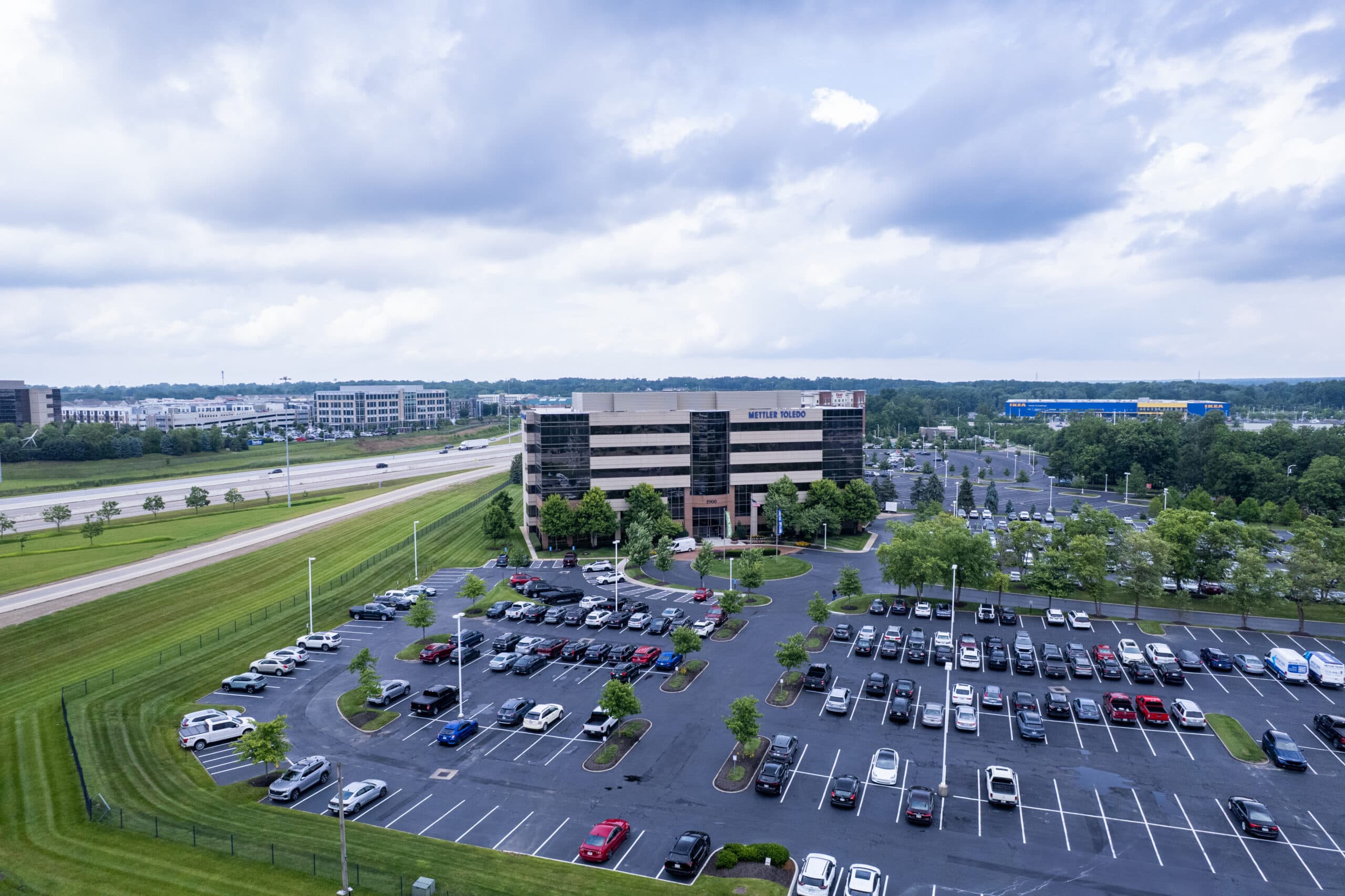 an aerial view of a commercial property with a large parking lot